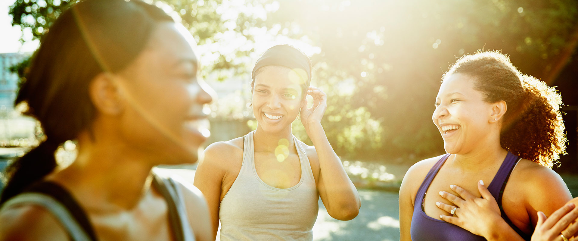 three women smiling together in conversation
